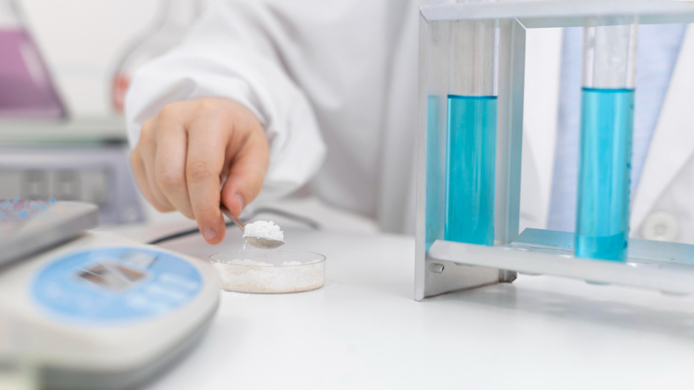 Laboratory technician conducting sugar testing in Qatar for beverage compliance and food safety analysis.