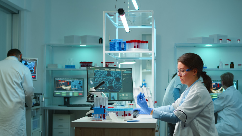 Modern laboratory technician conducting sample analysis in an advanced testing laboratory in Qatar using scientific equipment.