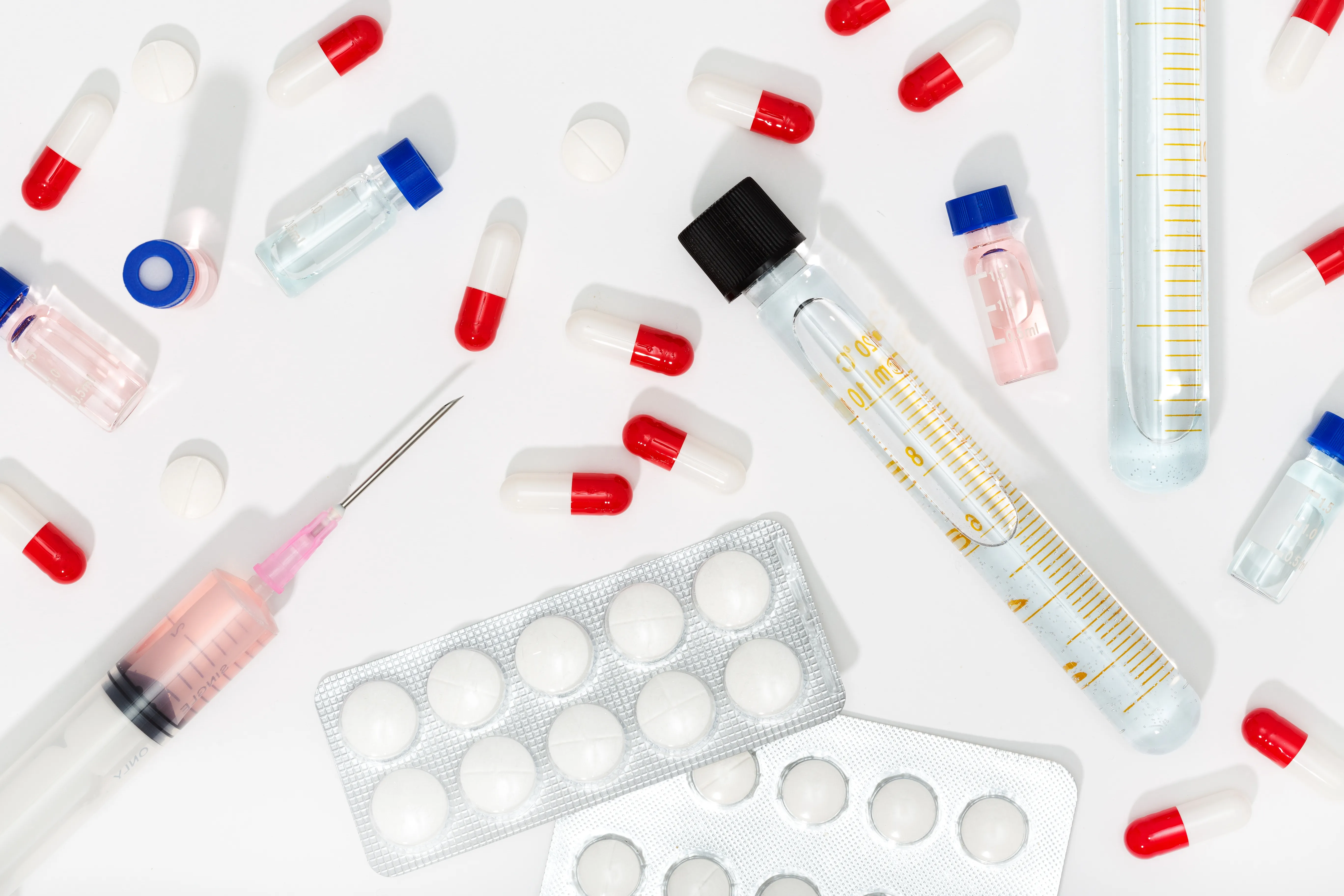 gloved hand holding test tube by river