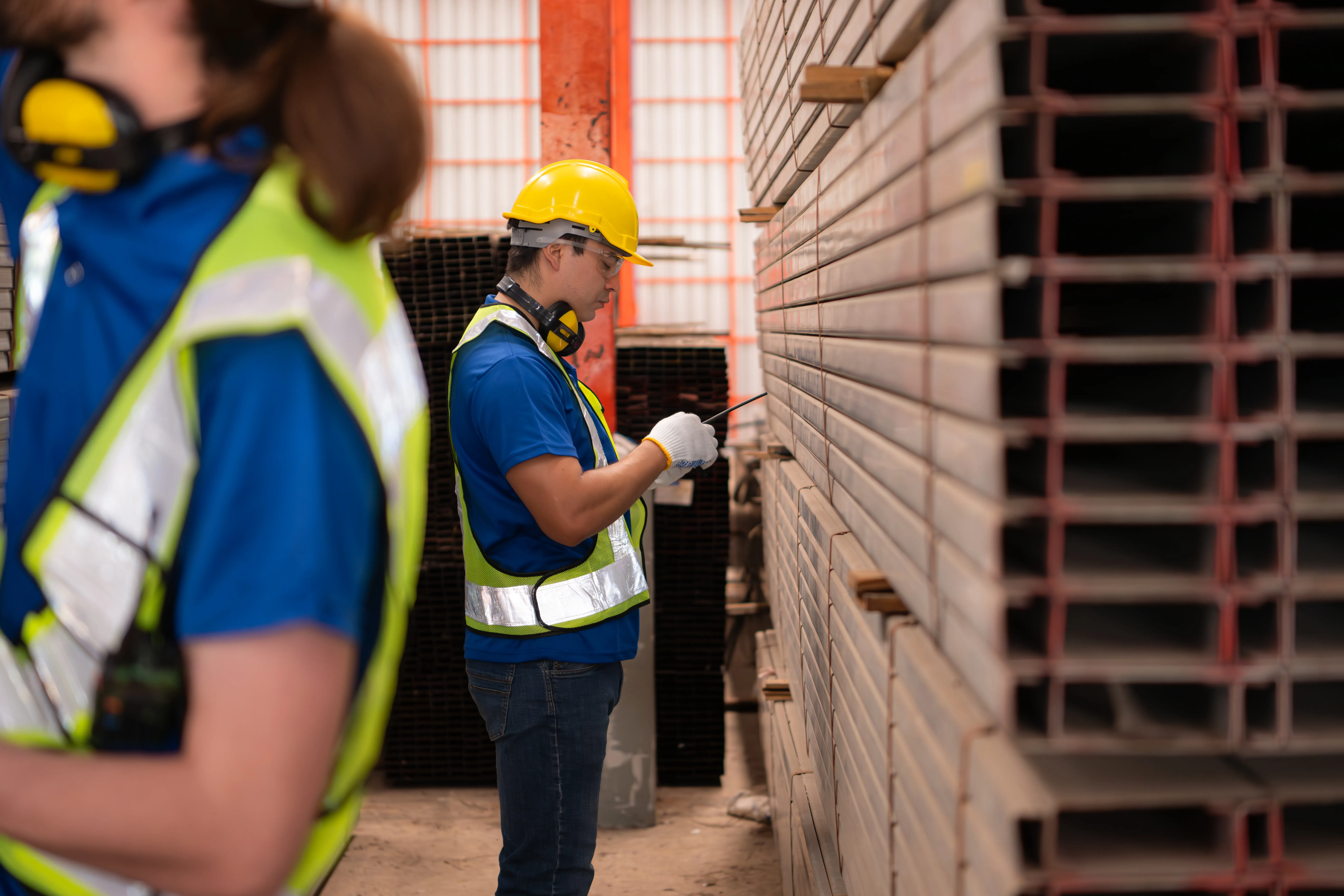 gloved hand holding test tube by river