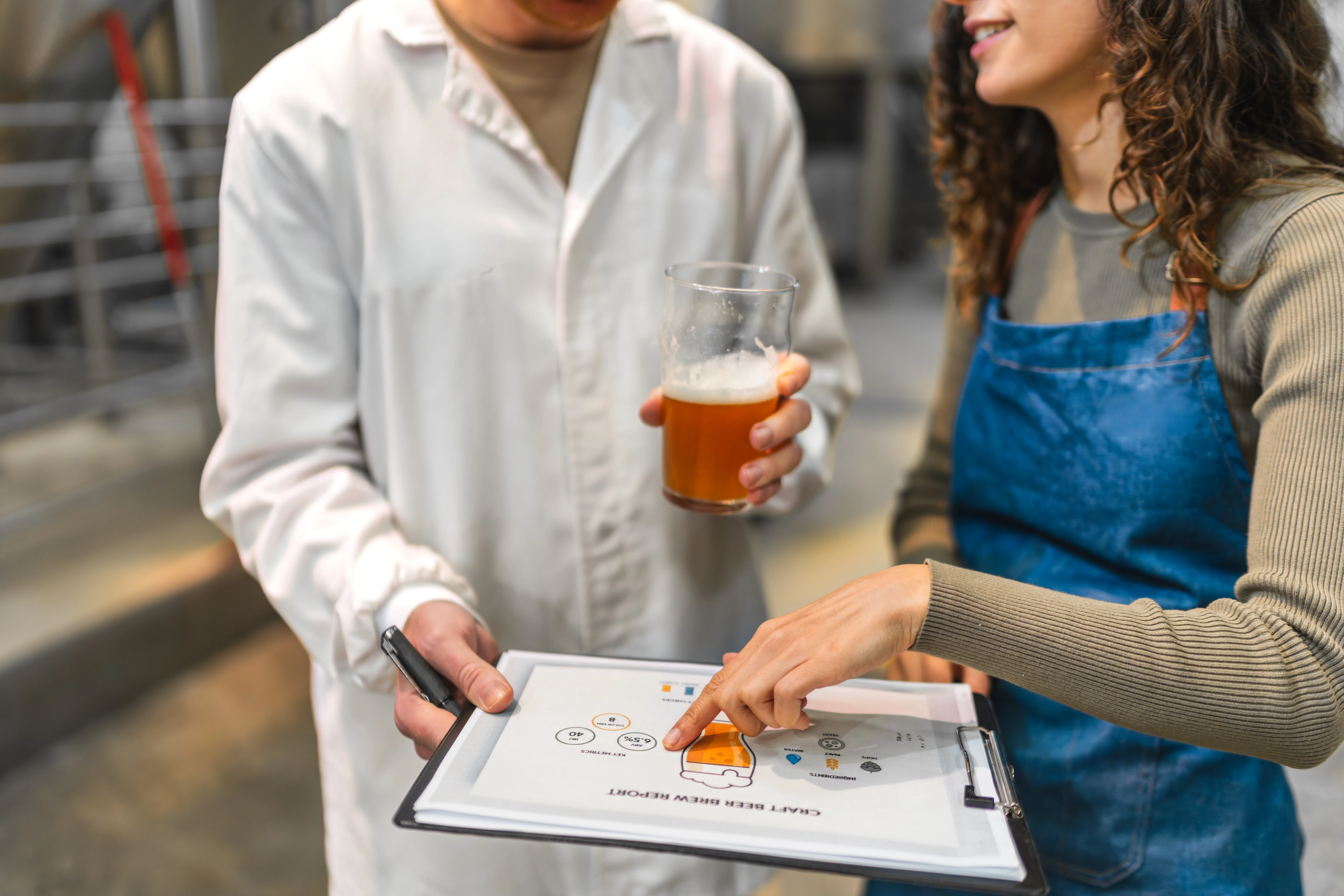 gloved hand holding test tube by river