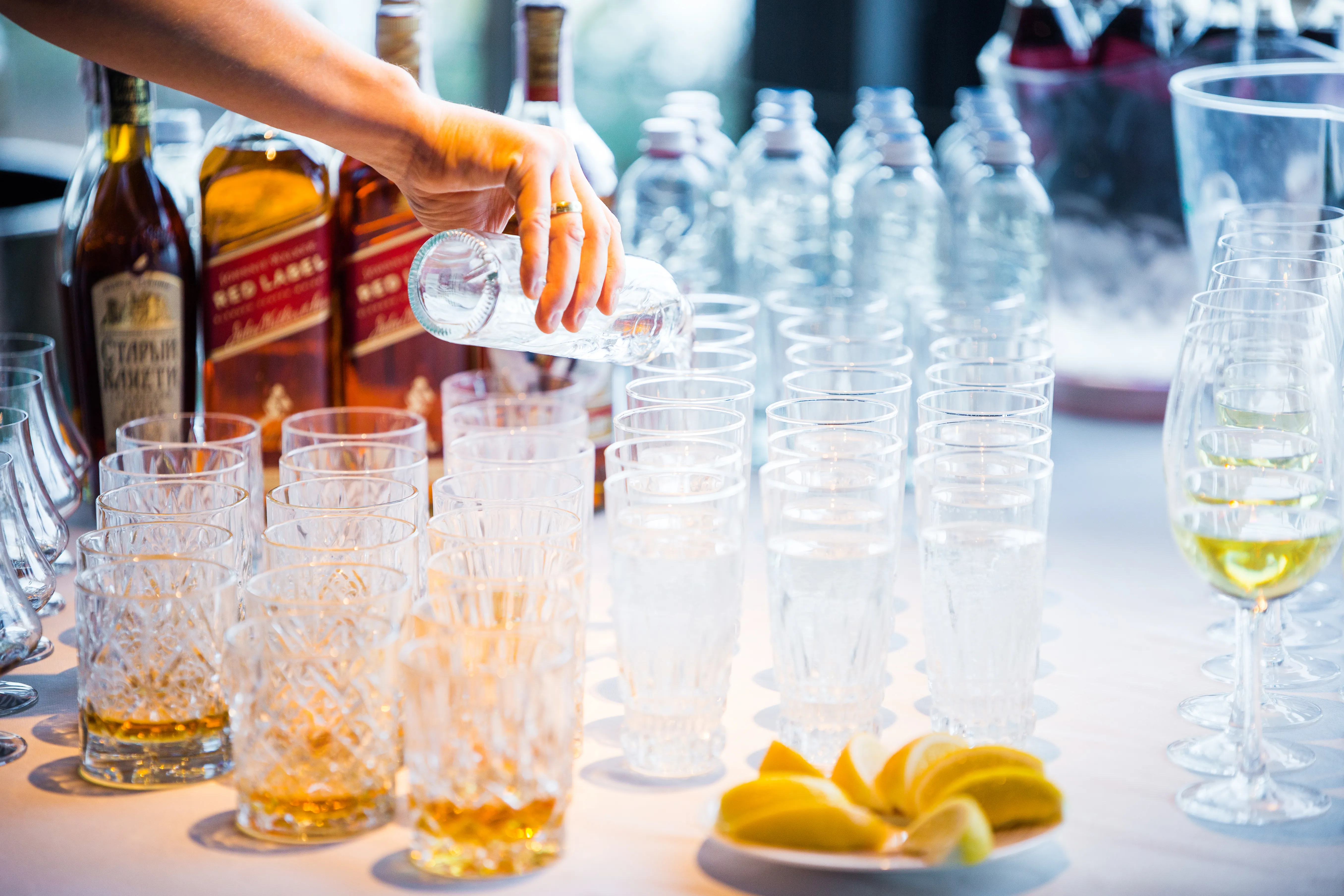scientist pouring water into beaker
