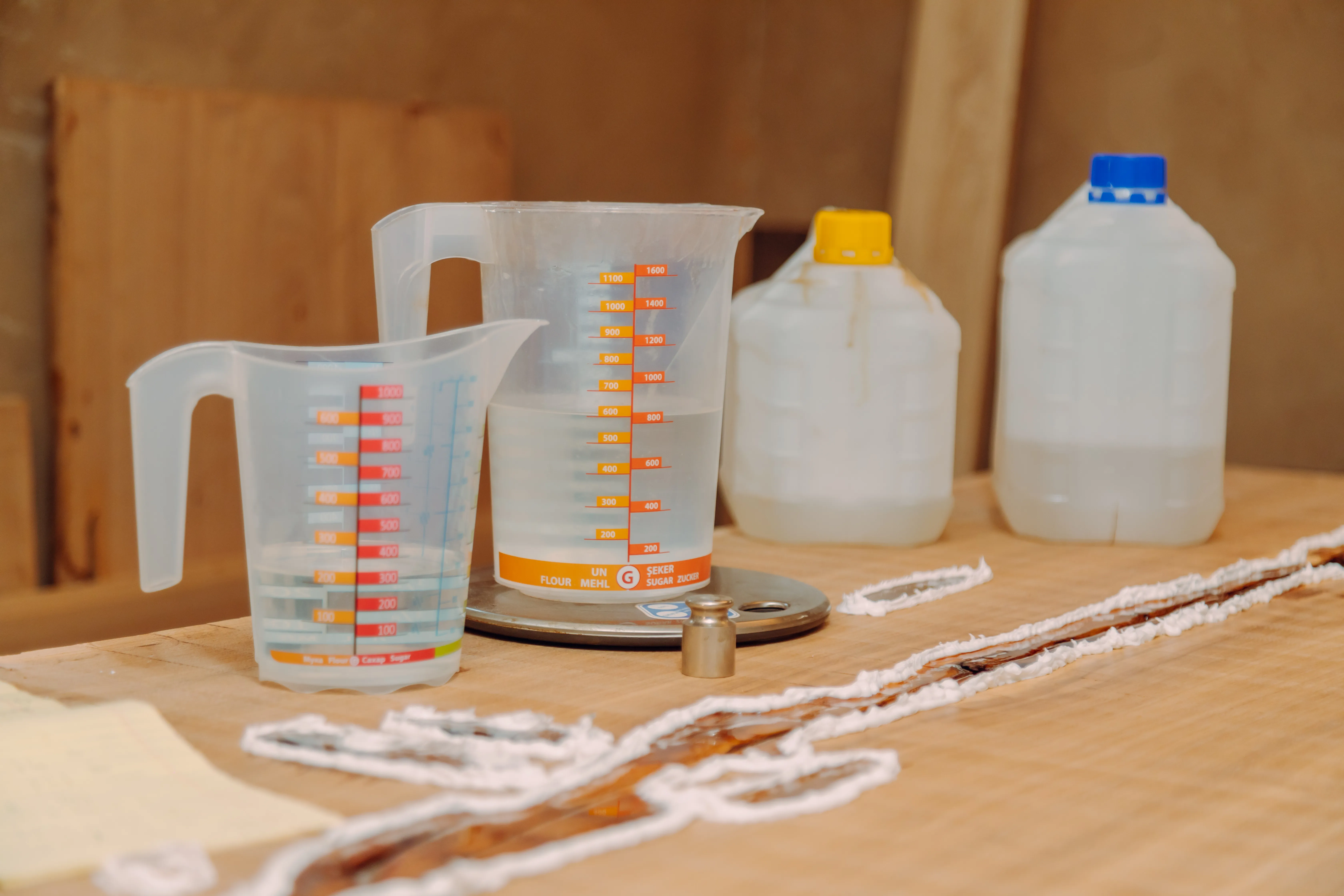 gloved hand holding test tube by river