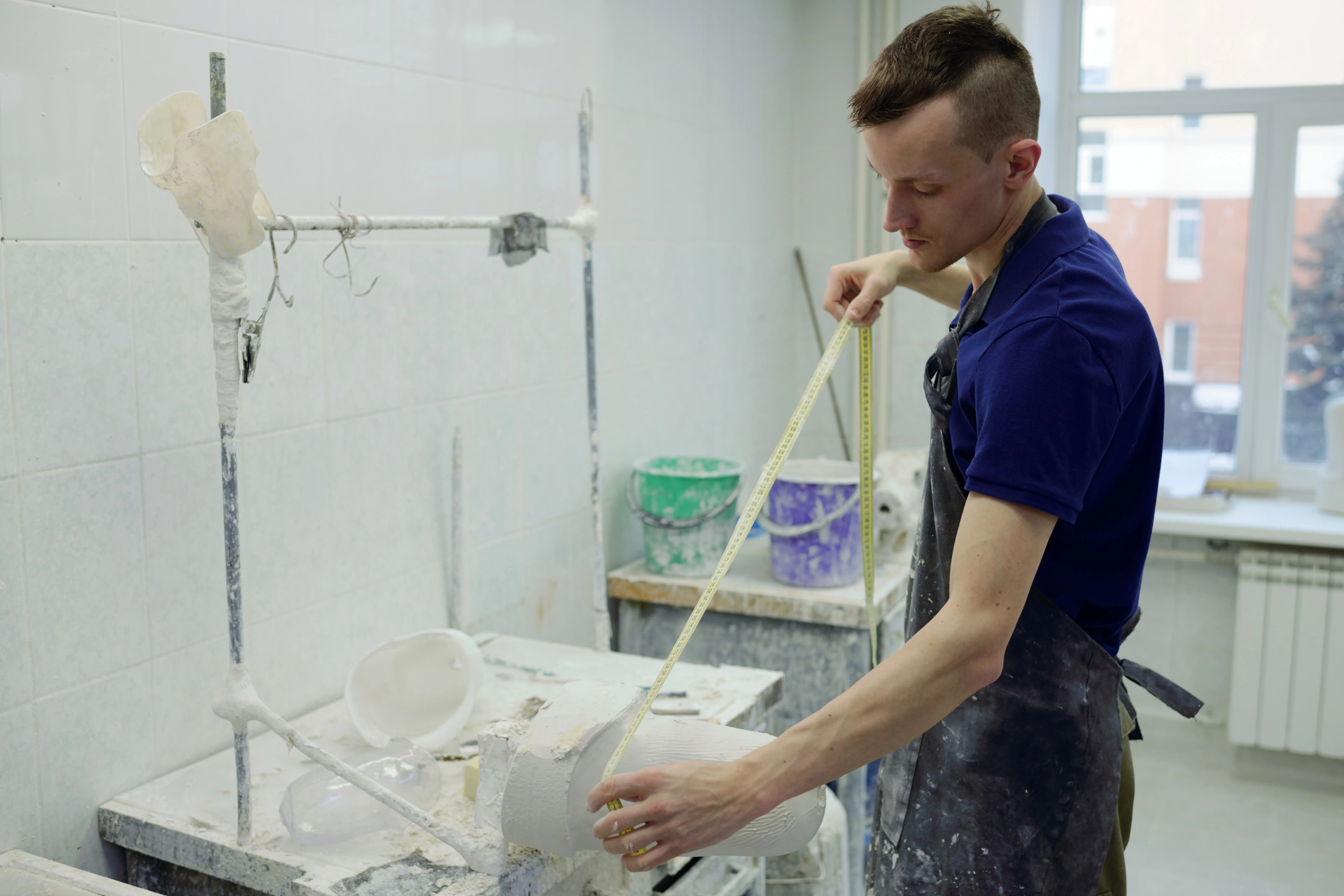 gloved hand holding test tube by river