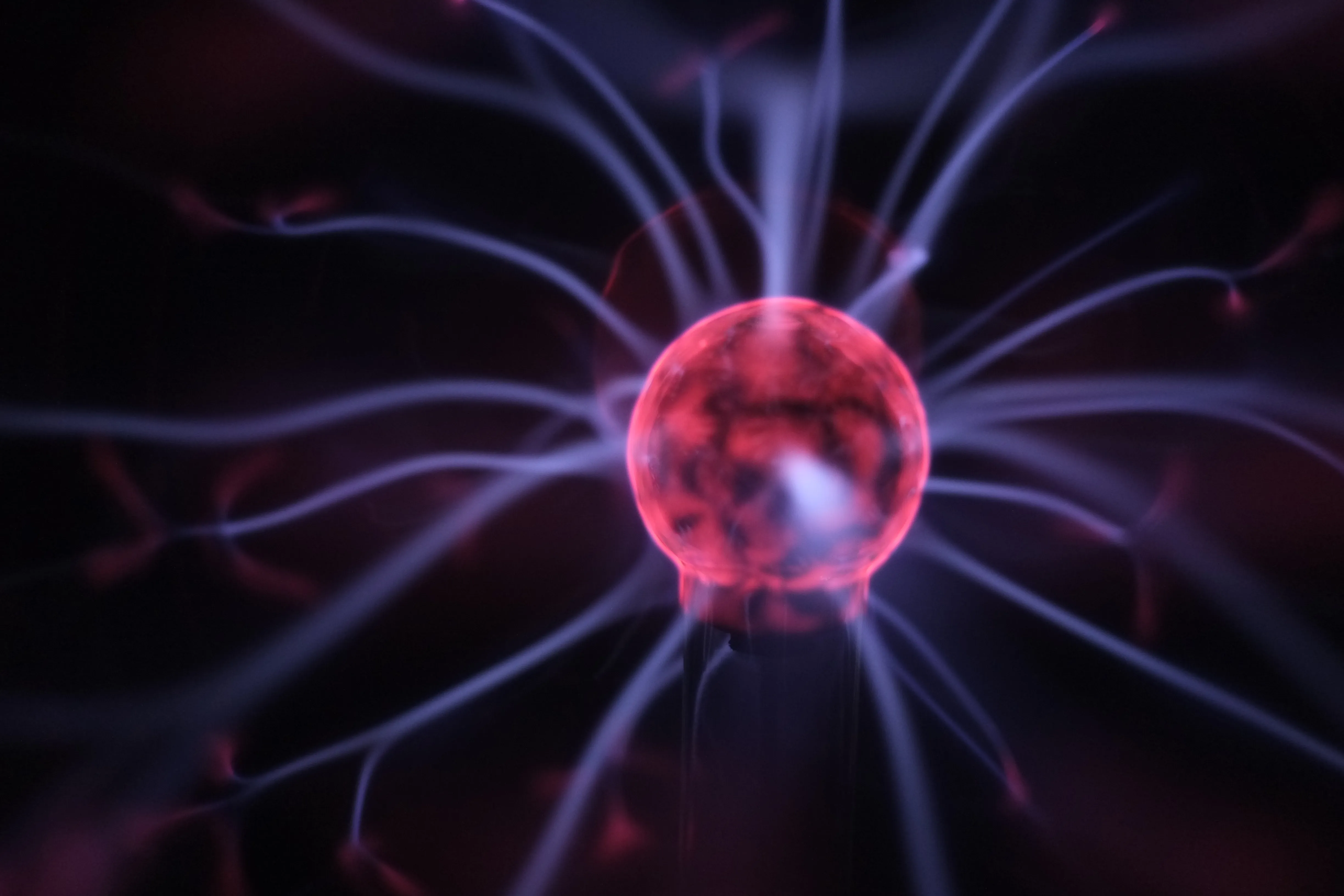 gloved hand holding test tube by river