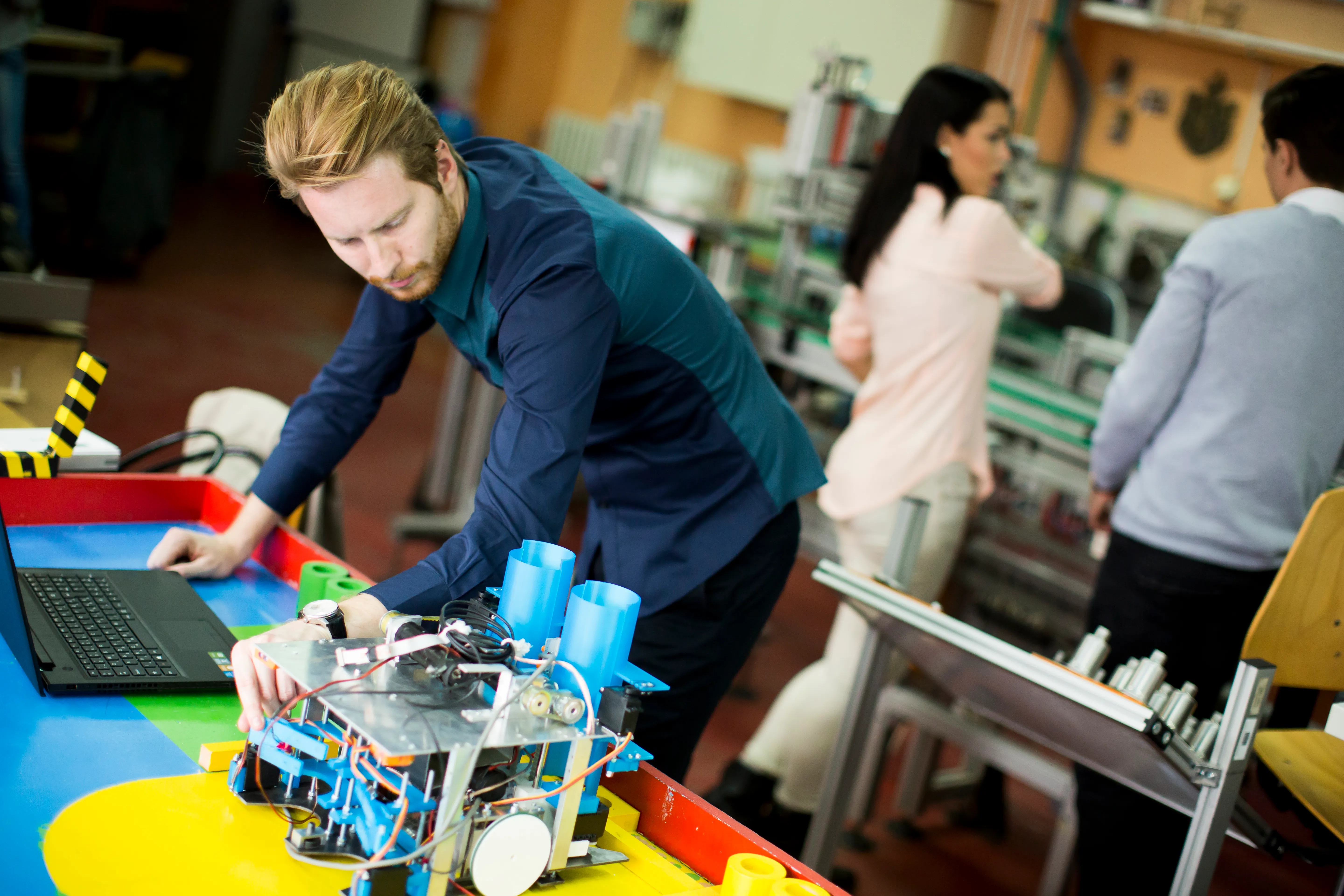 gloved hand holding test tube by river
